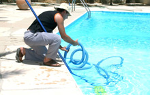 Man vacuuming pool